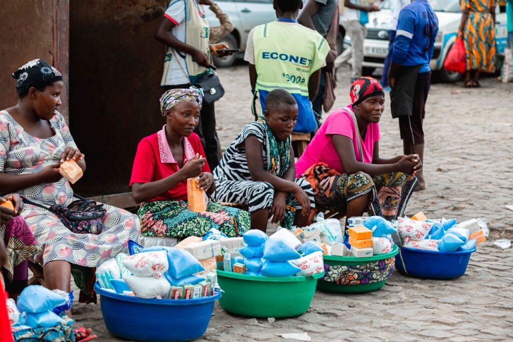 Women selling goods at a vibrant street market in Bujumbura, showcasing local commerce.